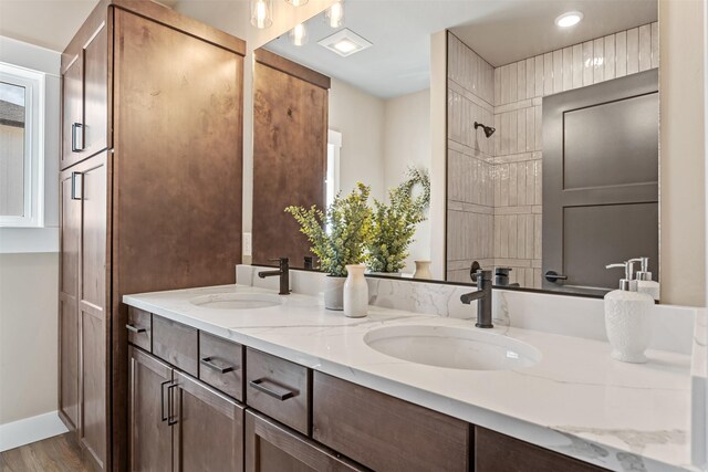 4337 Christian Dr, Missoula, MT 59803 - full bathroom with double vanity, wood finished floors, healthy amount of natural light, a tile shower, and recessed lighting