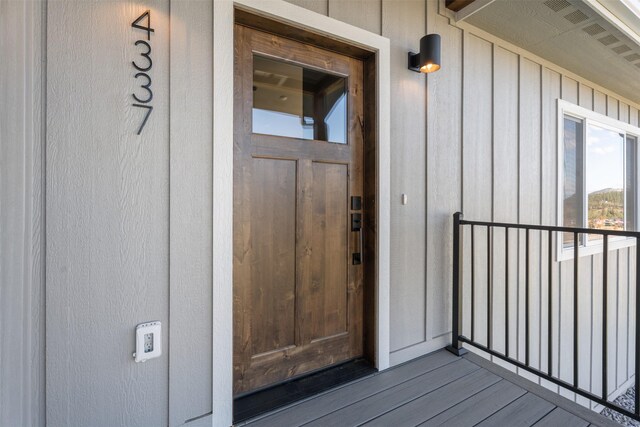 4337 Christian Dr, Missoula, MT 59803 - view of exterior entry featuring a balcony and board and batten siding