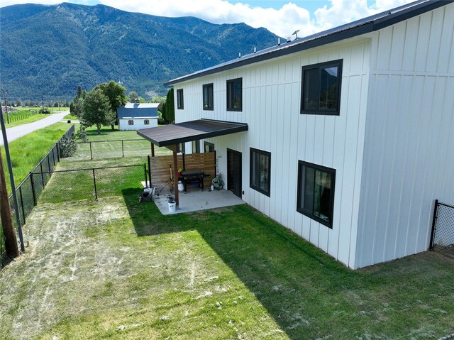 220 Columbia Meadows Dr, Columbia Falls, MT 59912 - back of property with a patio and a mountain view