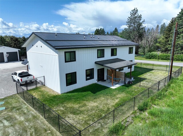 220 Columbia Meadows Dr, Columbia Falls, MT 59912 - back of house with metal roof and a patio area