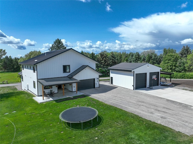 224 Columbia Meadows Dr, Columbia Falls, MT 59912 - rear view of house with a garage, a lawn, metal roof, and an outdoor structure