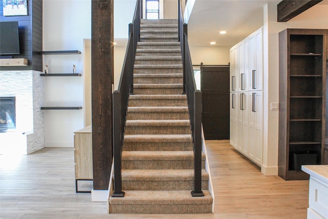 224 Columbia Meadows Dr, Columbia Falls, MT 59912 - stairs with wood finished floors, recessed lighting, and a stone fireplace