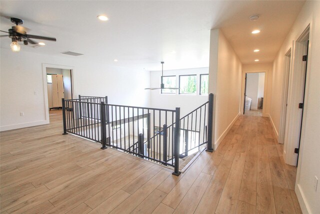 224 Columbia Meadows Dr, Columbia Falls, MT 59912 - corridor with an upstairs landing, light wood-type flooring, baseboards, and recessed lighting