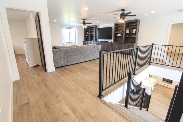 224 Columbia Meadows Dr, Columbia Falls, MT 59912 - living room featuring a ceiling fan, wood finished floors, and recessed lighting