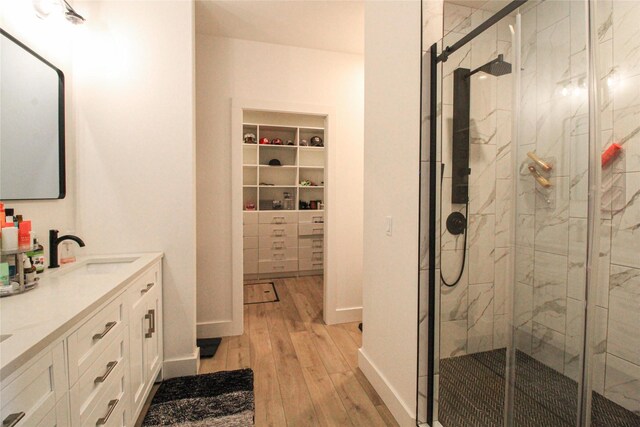 224 Columbia Meadows Dr, Columbia Falls, MT 59912 - full bath with wood finished floors, a marble finish shower, double vanity, and a walk in closet