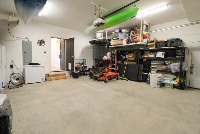 224 Columbia Meadows Dr, Columbia Falls, MT 59912 - garage featuring electric panel, fridge, and a garage door opener
