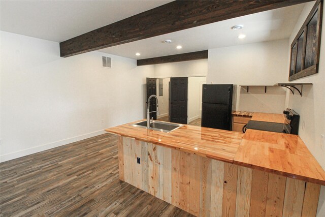 224 Columbia Meadows Dr, Columbia Falls, MT 59912 - kitchen featuring butcher block countertops, freestanding refrigerator, electric range, a sink, and beamed ceiling
