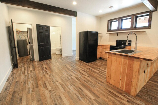 224 Columbia Meadows Dr, Columbia Falls, MT 59912 - kitchen featuring freestanding refrigerator, a sink, butcher block counters, dark wood-type flooring, and recessed lighting
