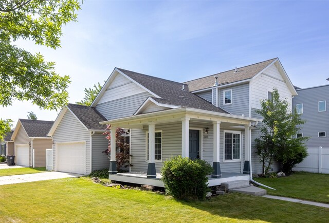 2322 Mary Jane Blvd, Missoula, MT 59808 - traditional-style house with covered porch, a shingled roof, an attached garage, and driveway