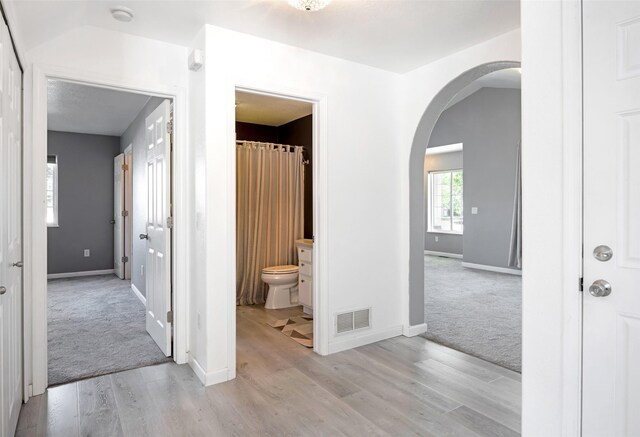 2322 Mary Jane Blvd, Missoula, MT 59808 - corridor featuring arched walkways, light wood-style floors, and baseboards