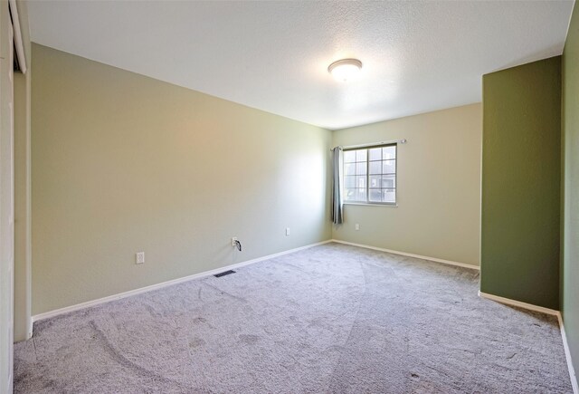 2322 Mary Jane Blvd, Missoula, MT 59808 - empty room with carpet flooring, baseboards, and a textured ceiling