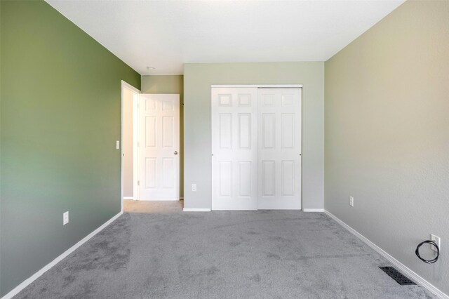 2322 Mary Jane Blvd, Missoula, MT 59808 - unfurnished bedroom with carpet floors, baseboards, and a closet