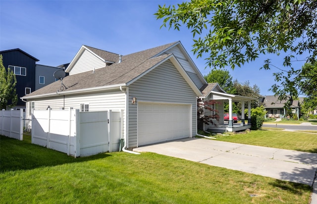 2322 Mary Jane Blvd, Missoula, MT 59808 - view of side of home featuring an attached garage, driveway, a shingled roof, and covered porch