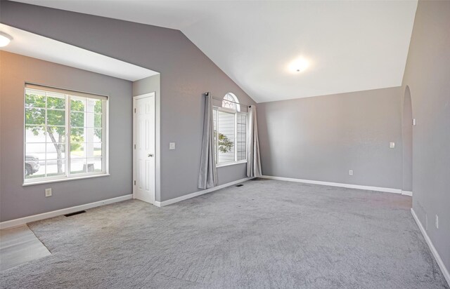 2322 Mary Jane Blvd, Missoula, MT 59808 - spare room with lofted ceiling, plenty of natural light, carpet, and arched walkways
