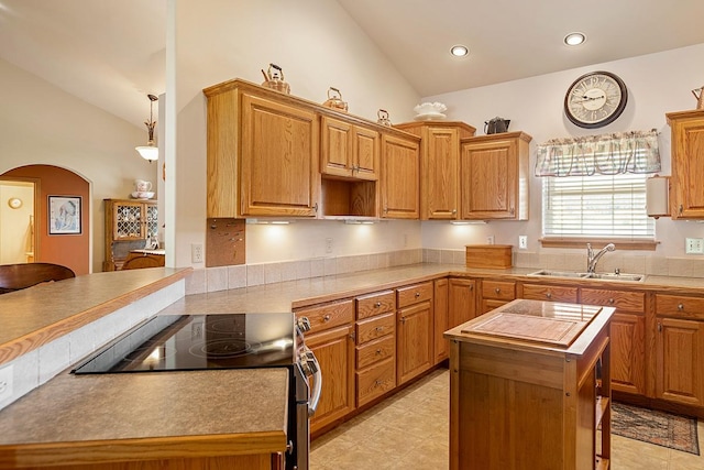 1 Cherry Ct, Clancy, MT 59634 - kitchen featuring stainless steel electric range, lofted ceiling, arched walkways, a kitchen breakfast bar, and a center island