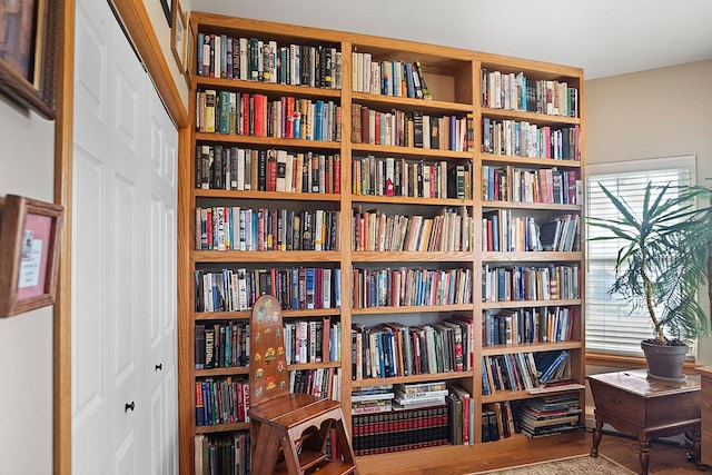 1 Cherry Ct, Clancy, MT 59634 - sitting room with wall of books and wood finished floors