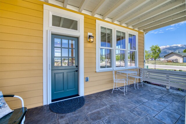 306 Mansion View Loop, Hamilton, MT 59840 - view of exterior entry with a porch and a mountain view
