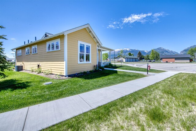 306 Mansion View Loop, Hamilton, MT 59840 - view of home's exterior with a mountain view, a lawn, and cooling unit