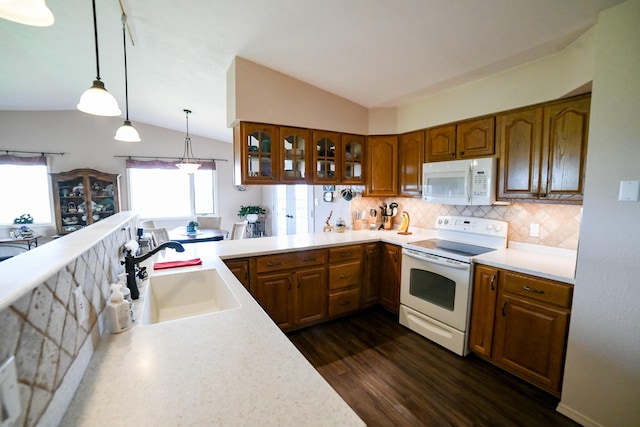 265 Fisher Rd, Great Falls, MT 59405 - kitchen featuring white appliances, a sink, brown cabinetry, lofted ceiling, and light countertops