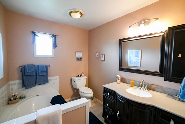 265 Fisher Rd, Great Falls, MT 59405 - full bathroom featuring vanity, a bath, toilet, baseboards, and wood finished floors