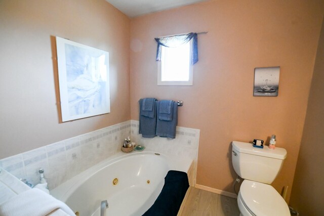 265 Fisher Rd, Great Falls, MT 59405 - full bath featuring a tub with jets, toilet, wood finished floors, and baseboards