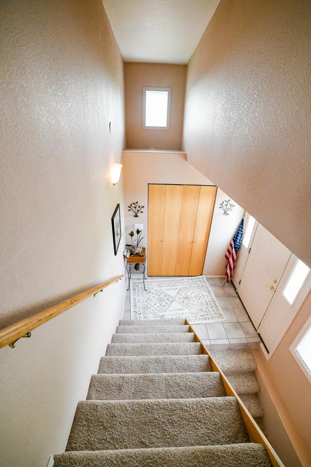 265 Fisher Rd, Great Falls, MT 59405 - stairs with a towering ceiling and tile patterned floors