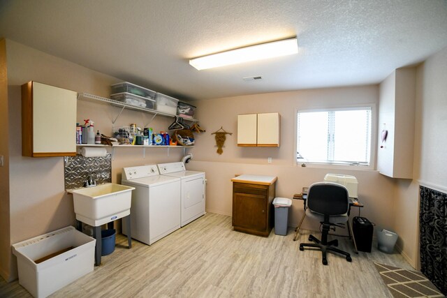 265 Fisher Rd, Great Falls, MT 59405 - laundry area featuring washer and dryer, light wood-type flooring, a desk, a textured ceiling, and cabinet space