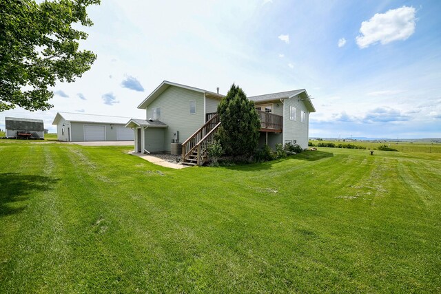 265 Fisher Rd, Great Falls, MT 59405 - rear view of property with a detached garage, a yard, a wooden deck, and stairway