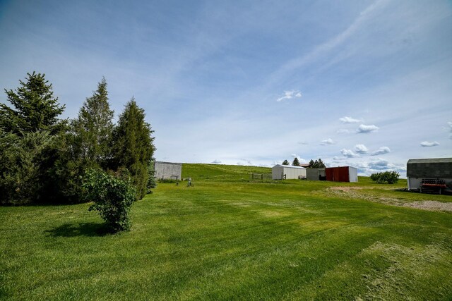 265 Fisher Rd, Great Falls, MT 59405 - view of grassy yard featuring an outbuilding, an outdoor structure, and driveway