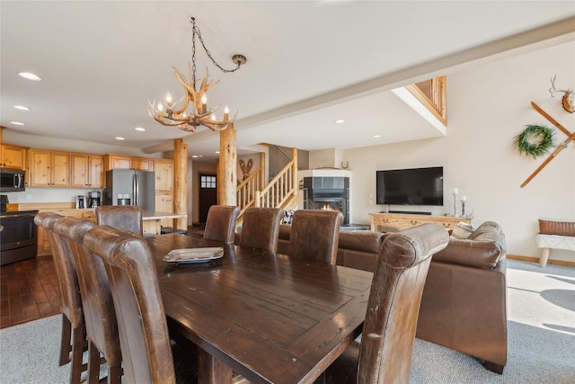 322 Wood Run Dr Unit B, Whitefish, MT 59937 - dining space featuring a chandelier, recessed lighting, stairs, baseboards, and a tile fireplace