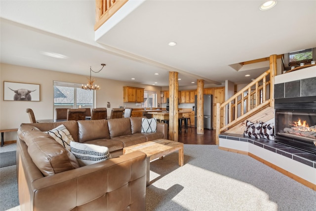 322 Wood Run Dr Unit B, Whitefish, MT 59937 - living area featuring recessed lighting, stairway, a chandelier, a tile fireplace, and carpet