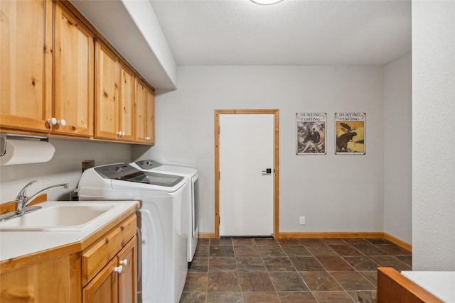 322 Wood Run Dr Unit B, Whitefish, MT 59937 - laundry room with cabinet space, washer and dryer, baseboards, and stone finish floors