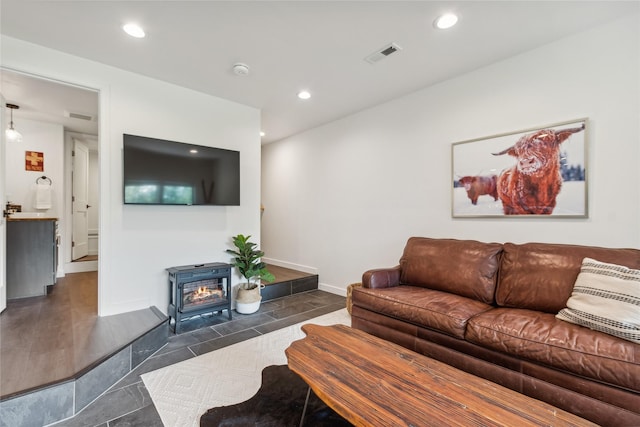 322 Wood Run Dr Unit B, Whitefish, MT 59937 - tiled living room featuring a wood stove, recessed lighting, and baseboards