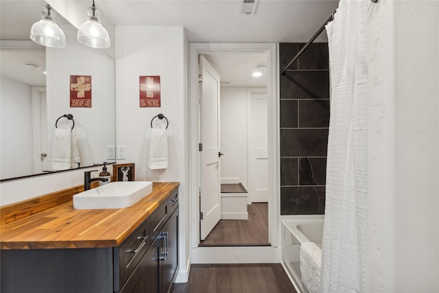 322 Wood Run Dr Unit B, Whitefish, MT 59937 - full bath with wood finished floors, vanity, and shower / tub combo with curtain