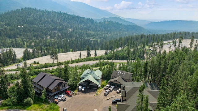 322 Wood Run Dr Unit B, Whitefish, MT 59937 - drone / aerial view of a heavily wooded area and a mountain backdrop
