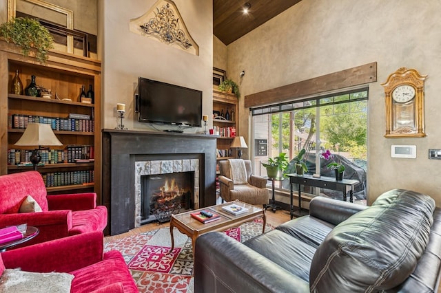 119 5th Ave W, Kalispell, MT 59901 - living area with high vaulted ceiling, built in features, a fireplace, and wood finished floors