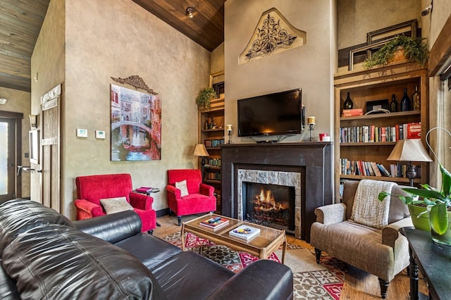 119 5th Ave W, Kalispell, MT 59901 - living room featuring wood ceiling, wood finished floors, a lit fireplace, built in features, and high vaulted ceiling