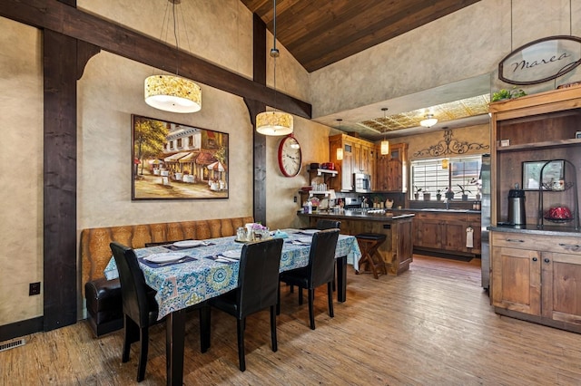 119 5th Ave W, Kalispell, MT 59901 - dining area featuring light wood-style flooring, wood ceiling with exposed beams, and high vaulted ceiling