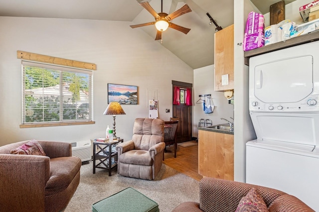 119 5th Ave W, Kalispell, MT 59901 - living room featuring stacked washer and clothes dryer, ceiling fan, track lighting, wood finished floors, and high vaulted ceiling