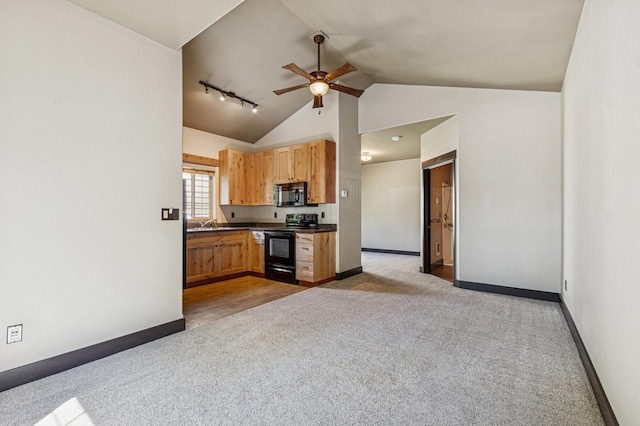 119 5th Ave W, Kalispell, MT 59901 - kitchen featuring black appliances, carpet floors, a ceiling fan, dark countertops, and baseboards