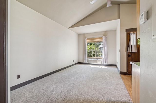 119 5th Ave W, Kalispell, MT 59901 - spare room with vaulted ceiling, light carpet, baseboards, and a wall mounted AC