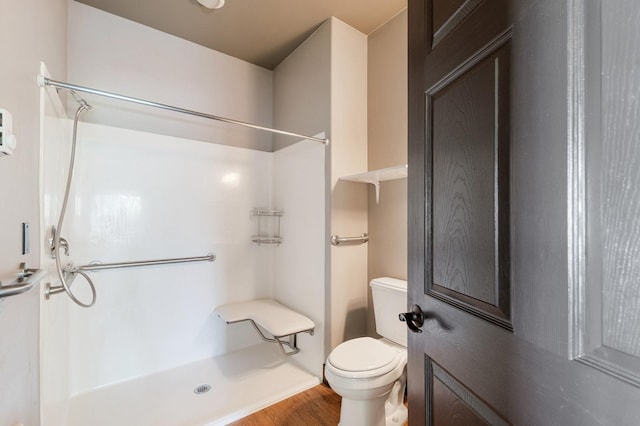119 5th Ave W, Kalispell, MT 59901 - bathroom featuring a shower, toilet, and wood finished floors