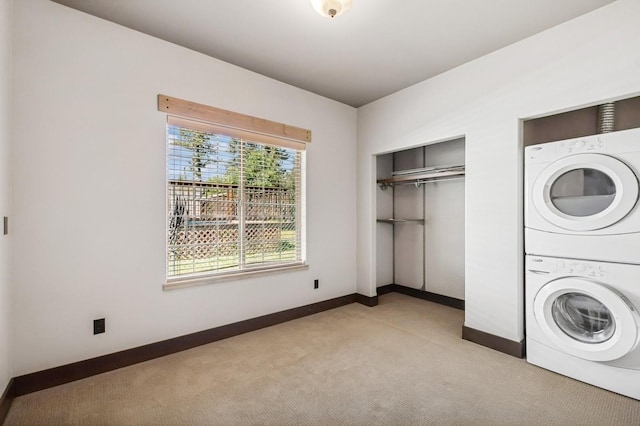 119 5th Ave W, Kalispell, MT 59901 - laundry area with stacked washer / drying machine, light colored carpet, and baseboards
