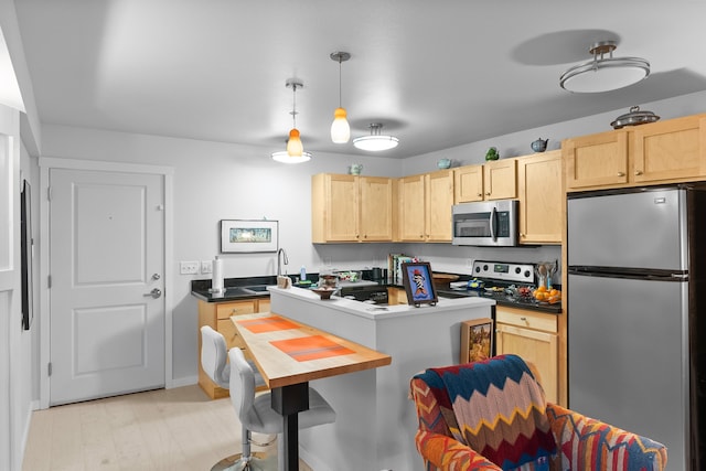 801 N Orange St Unit 108, Missoula, MT 59802 - kitchen featuring appliances with stainless steel finishes, light brown cabinetry, baseboards, and a sink