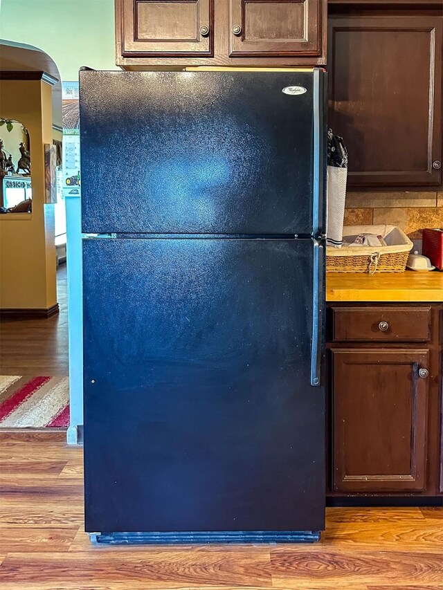 481 24th Rd NE, Dutton, MT 59433 - kitchen featuring freestanding refrigerator, light wood-style floors, and dark brown cabinets