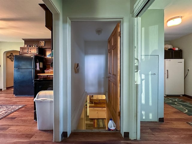 481 24th Rd NE, Dutton, MT 59433 - corridor featuring wood finished floors, baseboards, and arched walkways