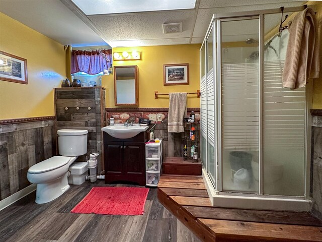 481 24th Rd NE, Dutton, MT 59433 - bathroom featuring vanity, a wainscoted wall, wood finished floors, toilet, and a shower stall