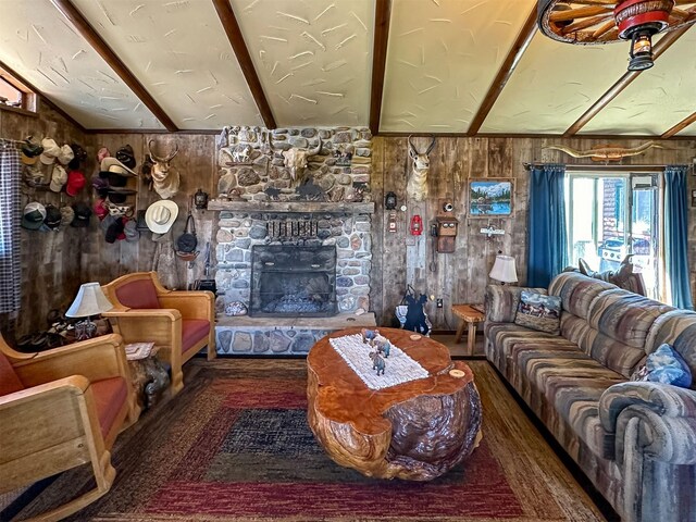 481 24th Rd NE, Dutton, MT 59433 - living room featuring wooden walls, a stone fireplace, and wood finished floors