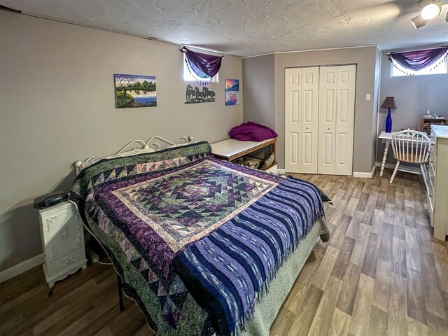 481 24th Rd NE, Dutton, MT 59433 - bedroom featuring wood finished floors, a closet, baseboards, and a textured ceiling