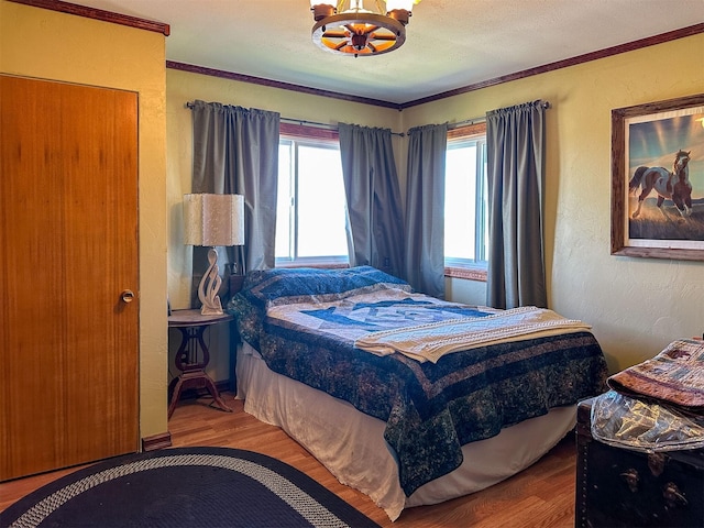 481 24th Rd NE, Dutton, MT 59433 - bedroom featuring wood finished floors, a chandelier, ornamental molding, and a textured wall